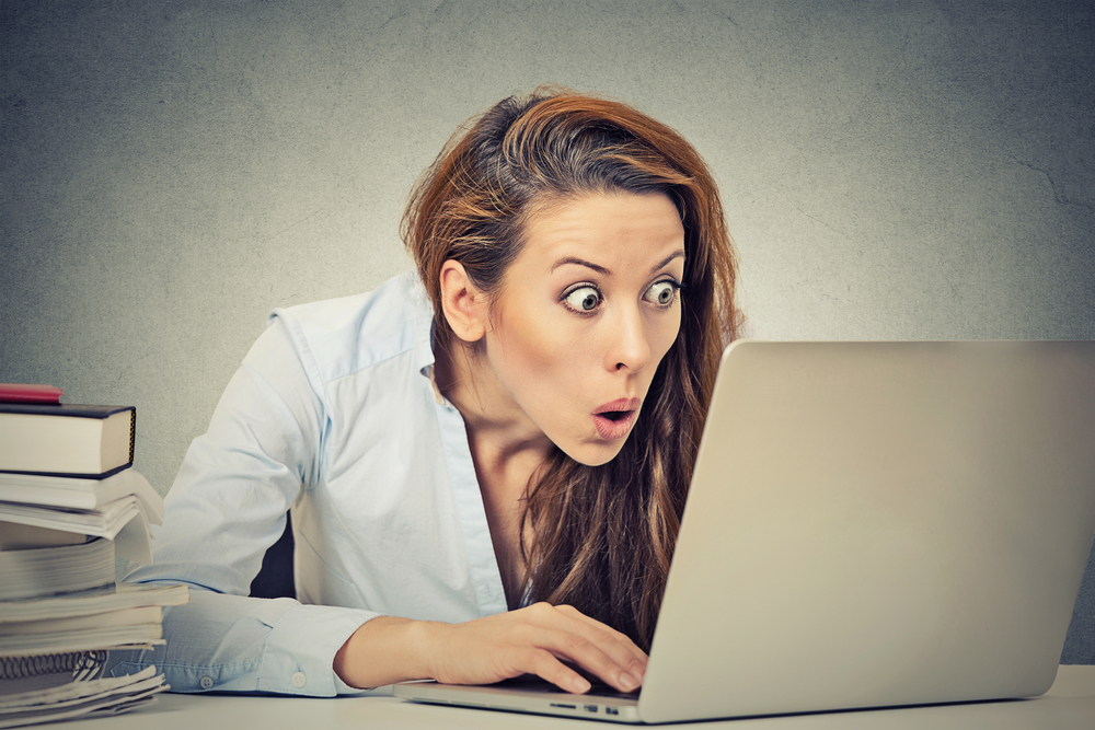 Person editing blog content on a laptop with an expression of shock/surprise